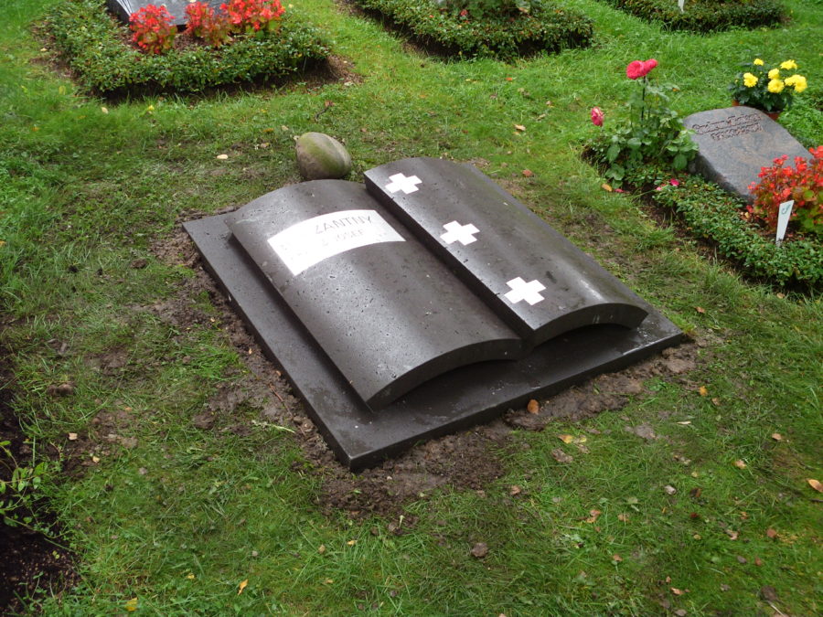 Liegeplatte in Form eines abstrakten Buches aus Basalt mit Edelstahlintarsien